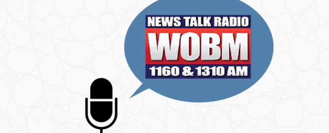 A microphone graphic with a speech bubble that contains the text "News Talk Radio WOBM 1160 and 1310 AM."