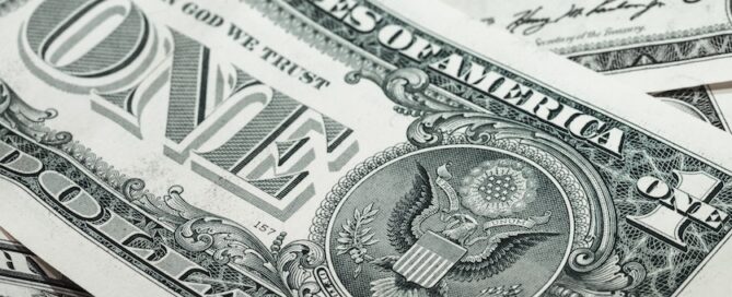 A close-up view of several one-dollar banknotes from the United States.