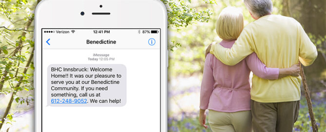 Older couple is seen walking together in a park, with a smartphone screen displaying a text message from "Benedictine" welcoming the recipient to the Benedictine Community.