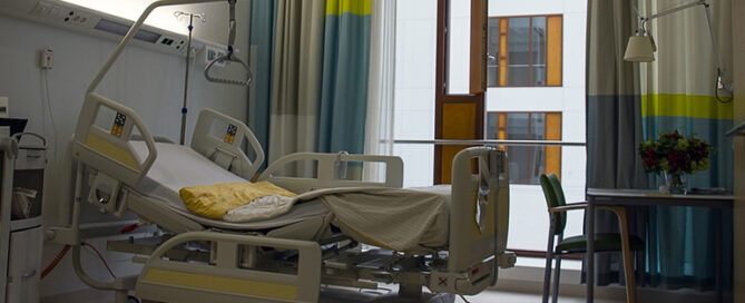 A hospital room with a patient bed.