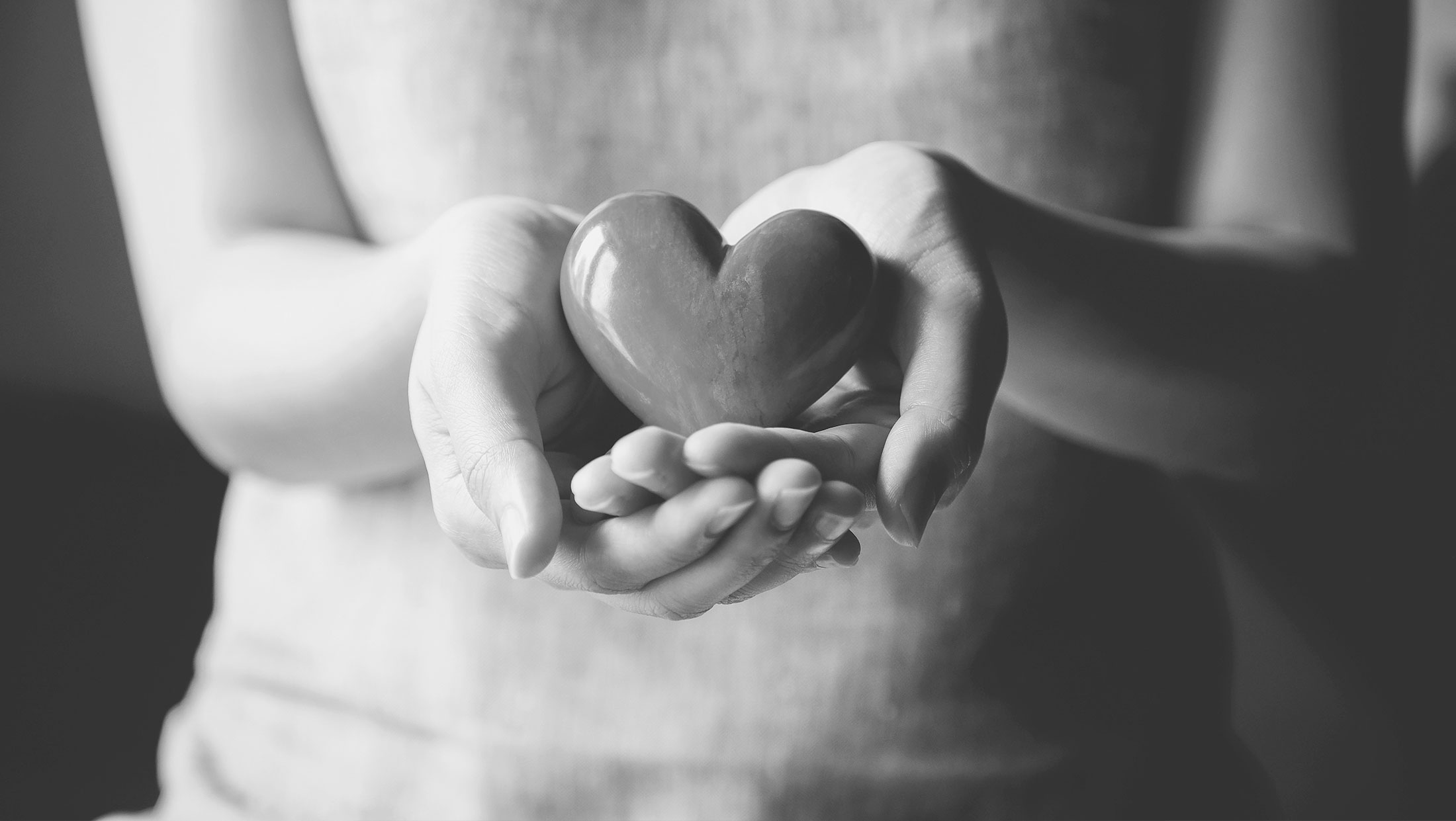 Hands Holding Glass Heart