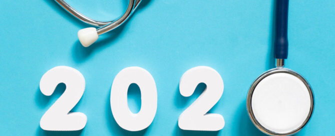 Image in a blue background with numbers "2020" made of white foam or plastic. A stethoscope is positioned next to the numbers.