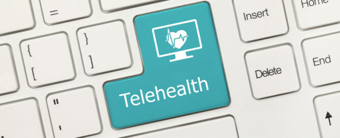 Computer keyboard where one of the keys is highlighted in turquoise, features the word "Telehealth".