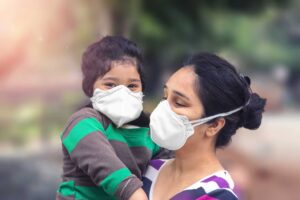 Mother and child wear facemask during coronavirus and flu outbreak.