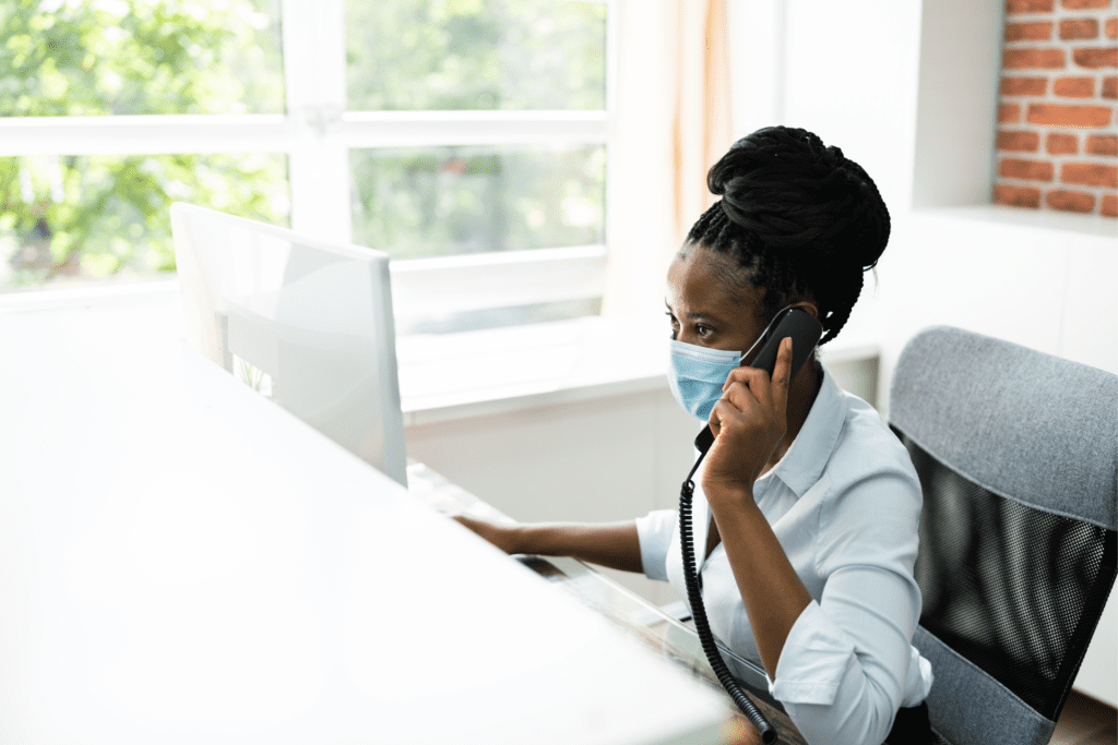 African american worker on the phone in front of a computer