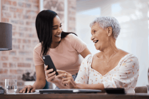 Two women smiling and enjoying a moment together.