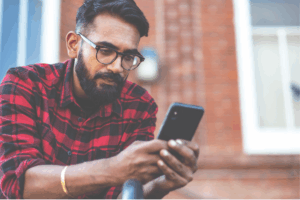 Man is using a smartphone.