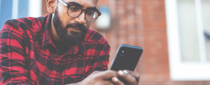 Man is using a smartphone.