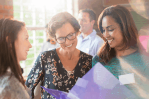 Three women engaging in conversation.