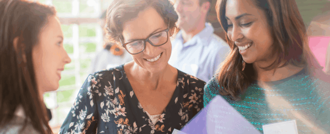 Three women engaging in conversation.