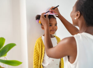 A woman measuring a young girl's height.