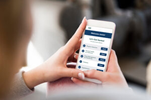 Young woman holding smart phone in hand.