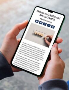 A person is holding a smartphone that displays an article titled "Behavioral Health and Mental Health".
