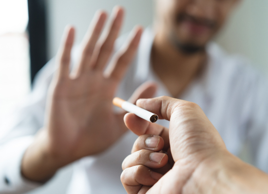 Man hold out his hand to refuse a cigarette